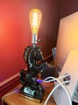 Black MCM horse lamp with gold accents and Edison bulb